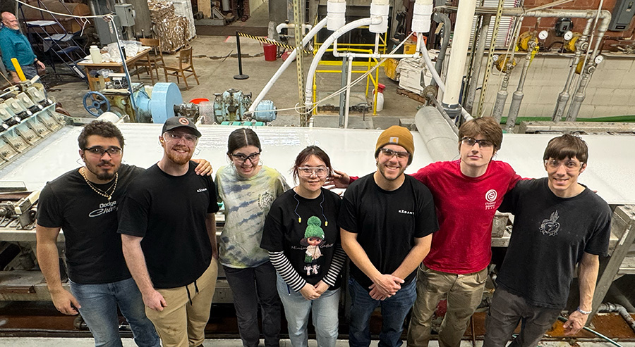 Group of students standing at the conclusion of a paper run.