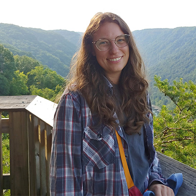 Marie Burdett standing in a flannel shirt