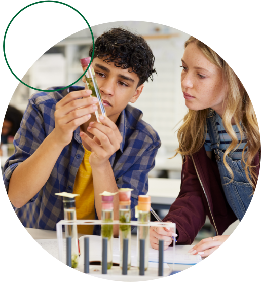 Two students examine a test tube in a laboratory.