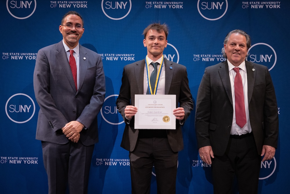 Eden Gardner stands with Chancellor John King and ESF's Mark Lichtenstein holding the Chancellor's Award